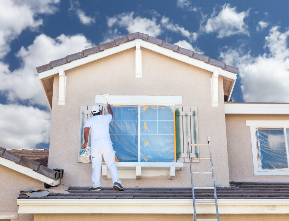 Man painting a house